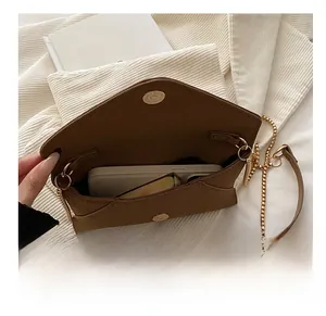 Internal view of brown PU leather envelope clutch showing large capacity for mobile phones