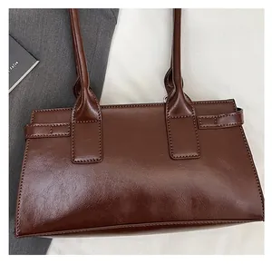Close-up of deep brown square tote bag featuring vintage wax-texture leather details