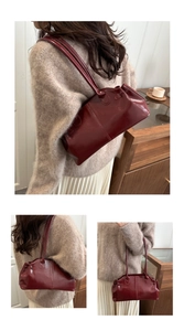 Detail showing high-gloss burgundy patent leather shoulder bag in a warm home setting