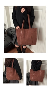 Close-up of brown suede tote bag featuring metallic silver studs and premium texture