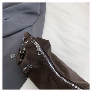 Detail shot of deep brown matte shoulder bag with high-quality silver metal zipper
