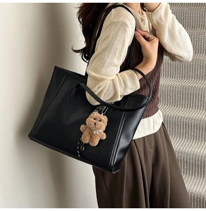 Elegant black large capacity leather tote bag with cute bear charm for daily commute