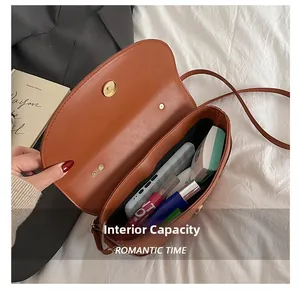 Macro view of the saddle bag interior showing large capacity for phone and cosmetics