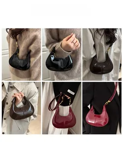 Chic patent leather crescent bag shown in black, brown and wine red color variants