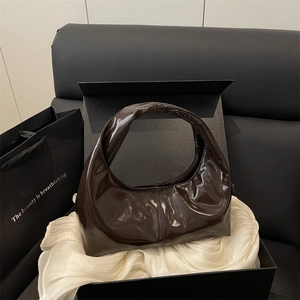 Glossy dark brown vintage tote bag in an elegant black gift box with white silk