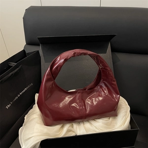 Vintage burgundy leather hobo handbag with a glossy finish shown in premium gift packaging