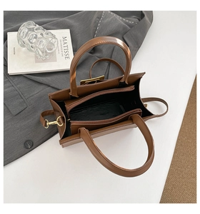 Top view of brown tote bag interior with zipper compartment and adjustable shoulder strap