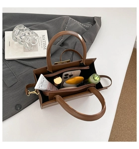 Internal view of brown leather handbag showing spacious storage for daily essentials