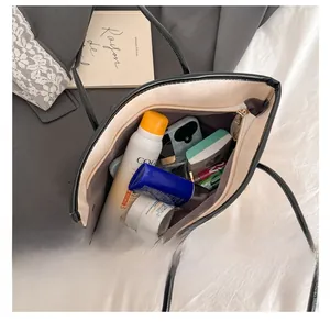 Top view of spacious interior with zipper pocket in beige faux leather tote bag