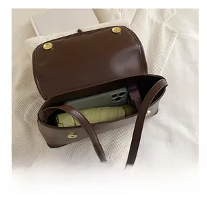 Interior view showing the large capacity of a retro brown leather baguette shoulder bag