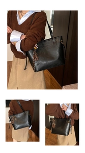 Close-up of black leather tote bag featuring drawstring detail and vintage charm