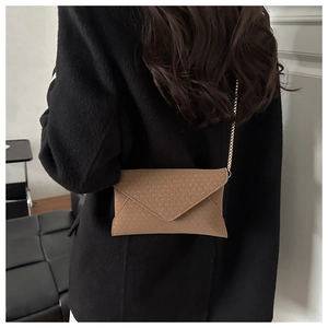 Khaki brown envelope chain bag with V-shaped woven texture on a person back view