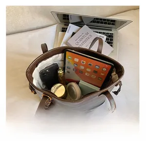 Interior view showing the large capacity of the vintage tote bag with tablet and wallet