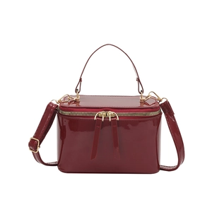 Luxe dark red patent leather box bag with gold hardware and adjustable strap