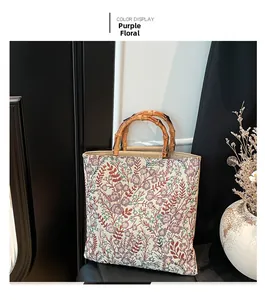 Detail of floral canvas tote bag featuring vintage bamboo handles and purple print