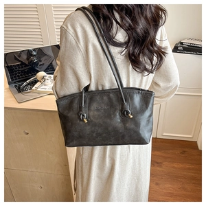 Detail of dark grey tote bag with FASHION & BAGS embossing and knotted shoulder straps