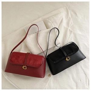 Detail showing suede and leather shoulder bags with gold G-buckle and flap closure