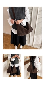 Detail view of large dark brown leather tote bag with soft matte texture and adjustable strap