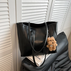 Classic large black tote bag in textured faux leather with cute brown bear charm