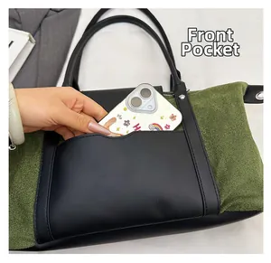 Detail view of the front pocket on the vintage paneled tote bag for smartphone storage