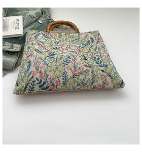 Detailed shot of floral jacquard tote bag featuring authentic natural bamboo handles