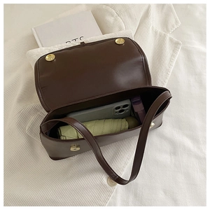 Top view of dark brown leather handbag showing interior capacity and golden magnetic closure