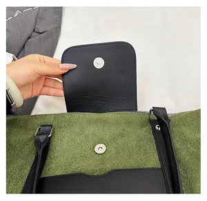 Detail of the high-quality silver magnetic snap closure on the green textured handbag
