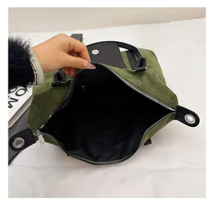 Detailed interior of green corduroy travel tote showing spacious lining and zip closure