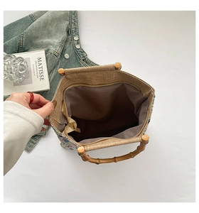 Detail showing the inner zipper pocket and woven texture of the tote bag with bamboo handle
