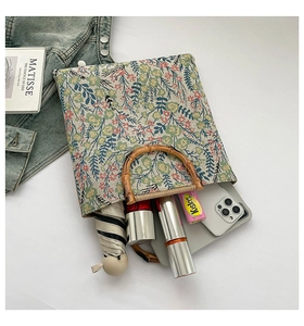Spacious floral woven tote bag showing bamboo handles and daily essentials storage