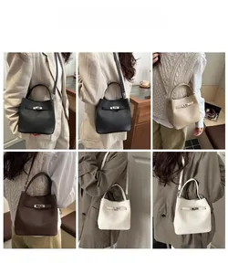 Macro detail of lychee pattern leather and metallic buckle on versatile bucket bag