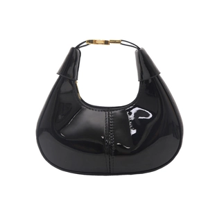 Fashionable black patent leather hobo bag with gold hardware and crescent moon shape