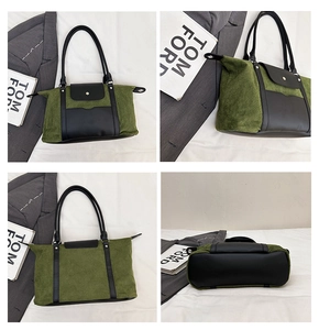 Detail view of olive green corduroy tote bag with black leather trim and metal clasp