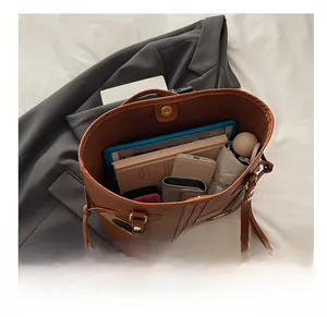 Top view of large brown PU leather tote bag interior showing ample storage capacity