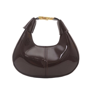 Dark brown patent leather hobo bag with crescent shape and gold buckle detail