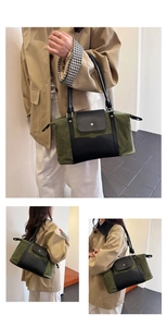 Detail view of large olive canvas and black leather shoulder bag with metallic snap closure