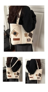 Close-up of vintage cream PU leather tote bag with decorative fashion lucky patches