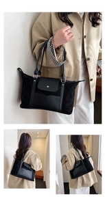 Detail of a black patchwork tote bag with smooth leather and suede textures on a model