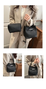 Detail of black pebbled leather bucket bag with silver turn-lock and small zip pouch