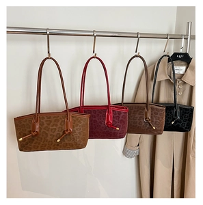 Detailed display of four leopard print leather tote bags in various autumn colors