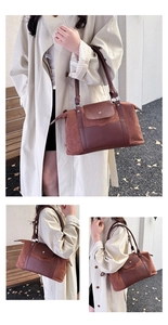 Detail shot of vintage brown patchwork travel bag showing suede texture and leather straps