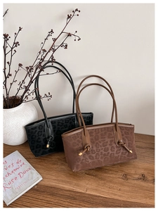 Detailed macro of leopard print suede texture and stylish knotted shoulder strap bags