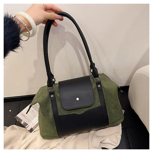 Detail of vintage moss green suede and black leather shoulder bag with magnetic flap