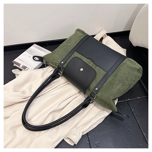 Top-down view of army green canvas tote with black leather trim and front magnetic pocket