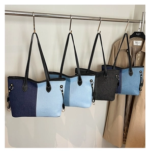 Detail view of denim tote bags in dark blue, sky blue, charcoal gray and classic denim