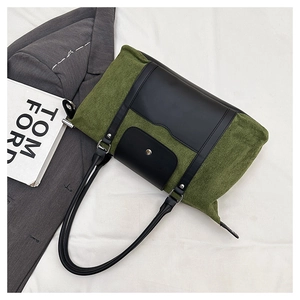 Detail of olive green vintage tote bag with black leather straps and metal buckle