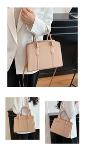 Detailed view of beige crocodile embossed pattern and fashion bag New York logo text