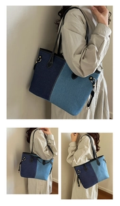Detail of color-block denim tote bag with black leather straps and gold metal rings