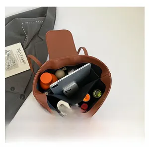 Detailed internal view of brown leather tote bag showing large capacity for essentials