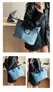 Detail of blue denim and corduroy patchwork tote bag with stylish leather shoulder straps